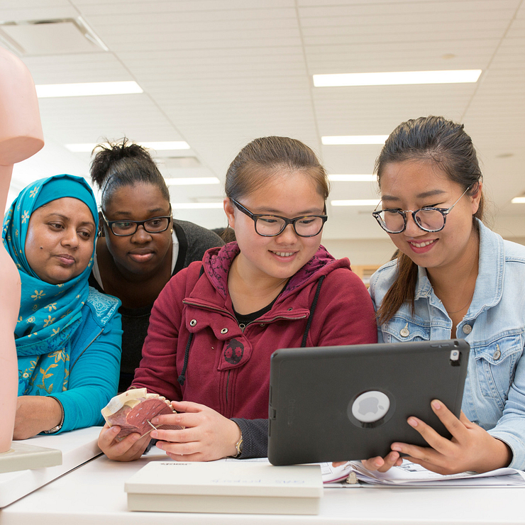 students viewing a laptop